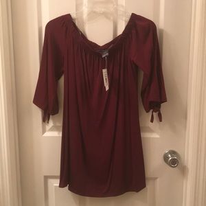 Off the shoulder maroon top.